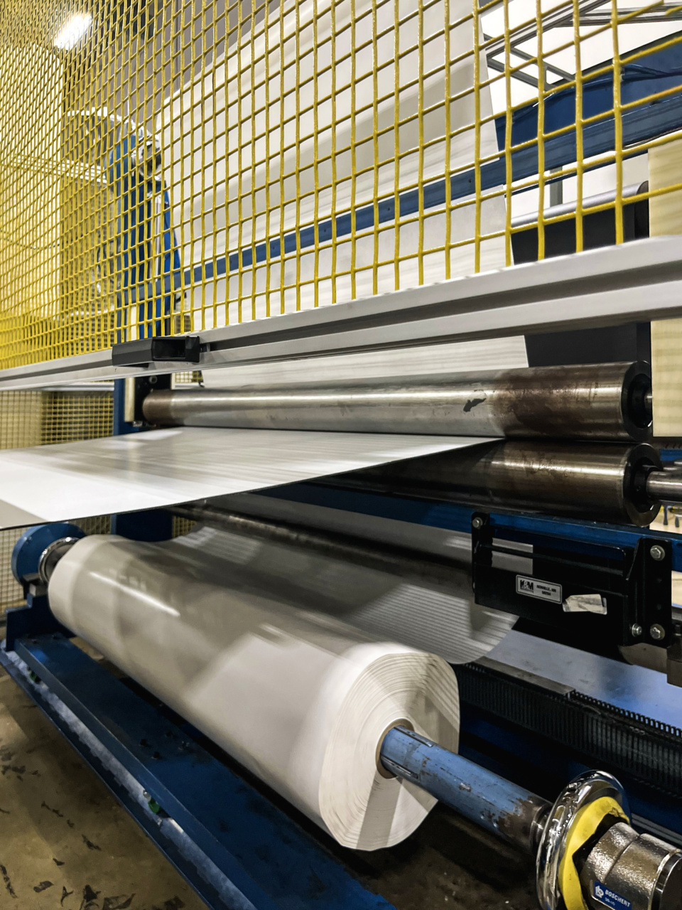 Wide web adhesive lamination